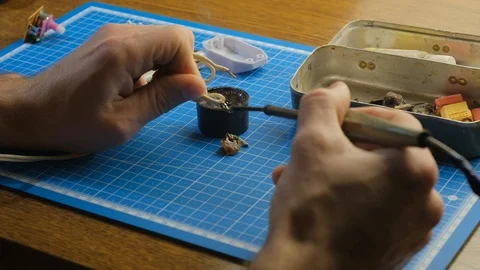 Soldering small parts by hand using good old methods. 4k Stockbeeldmateriaal 102204087