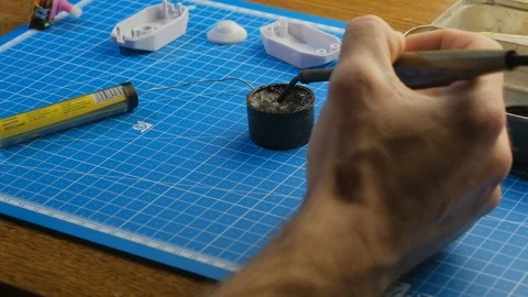 Soldering small parts by hand using good old methods. 4k Stockbeeldmateriaal 102204213