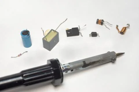 Soldering tool with several components of electronics in a row Stock Photos