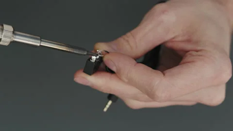 Soldering wires to a button Video stock 237145611