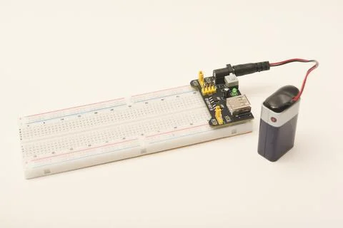A solderless board for electronics with a battery. A breadboard for experim.. Stock Photos
