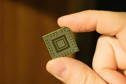 Solderless computer bga chip in hand closeup Stock Photos