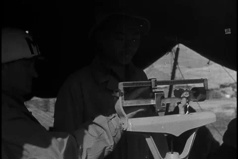 Soldier adjust stadiometer to measure height of POW - 1951 Stock Footage 106048467