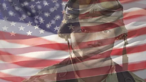 Soldier adjusting strap, camera pulling back revealing face, flag overlay Video stock 321099681