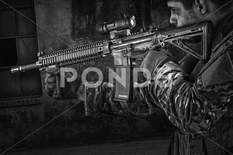 Photograph: Soldier aiming automatic weapon during training #65129282