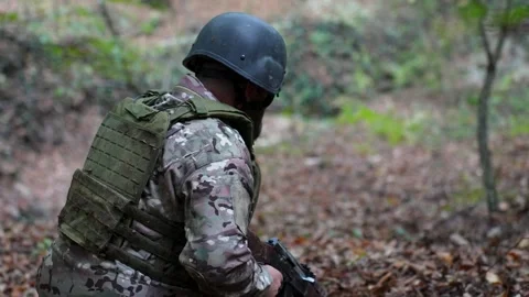 Soldier aiming rifle during combat training in forest Stock Footage 320770206