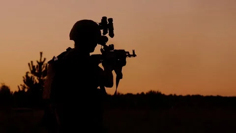 Soldier aiming rifle at sunset Stock Footage 320602473