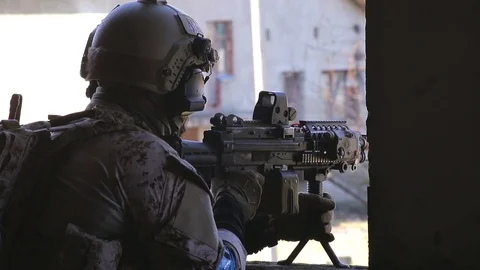 Soldier is aiming at the target with machine gun Stock Footage 81672156