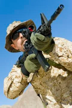 Soldier Aiming Through Gunsight Against Blue Sky Фото