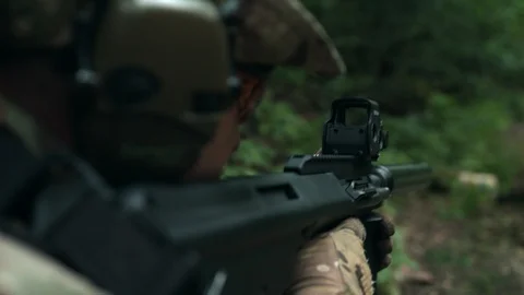 The soldier aims at the target. Fully equipped soldier. Video stock 107792542