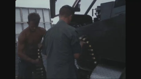 Soldier and instructor pilot load 40mm grenades on AH-1G - 1969 Stock Footage 96143702