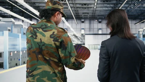 Soldier and microchip factory engineer discuss about silicon wafer Stock Footage 333393307