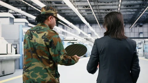 Soldier and microchip factory engineer discuss about silicon wafer Stock Footage 333395337
