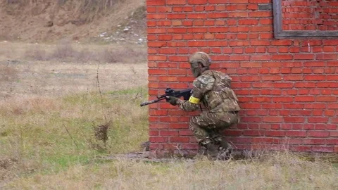 Soldier with automatic rifle in the city Stock Footage 81672867