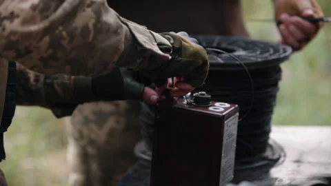 Soldier in camouflage with explosives in his hands, miner preparing explosive Stock Footage 203918802