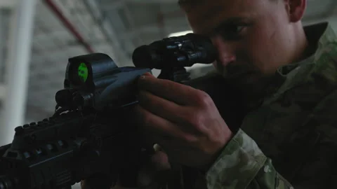 Soldier checking scope on weapon Stock Footage 275093042