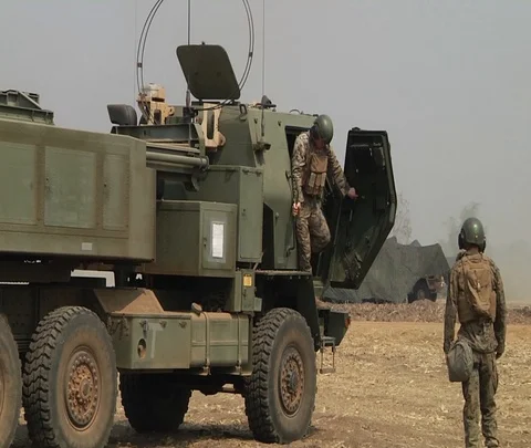 Soldier climbs down from high mobility artillery rocket system during live fire Видео 102944174