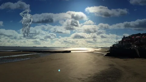 Soldier in the clouds saluting on a Normandy d-day beach. Arromanches Stock Footage 118139726