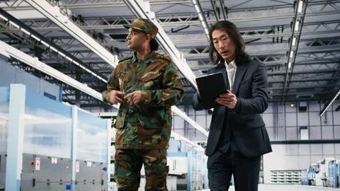 Soldier collaborating with microchip production factory manager Stock Footage 333395146