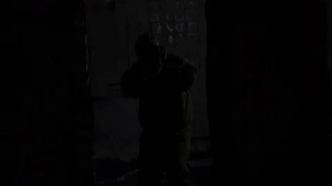 Soldier comes out of the shadows and makes shots. operation  Stock Footage 101690735