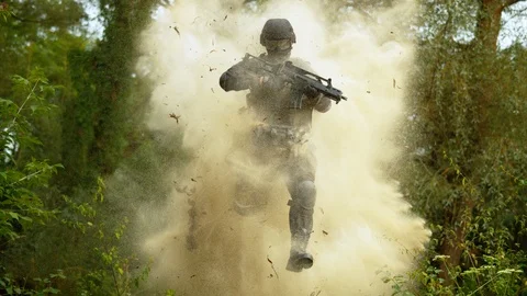 Soldier coming out from the explosion, slow motion Stock Footage 86457980