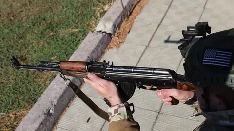 The soldier crouched down and fired from an automatic weapon. A real war, an Stock Footage 303623069