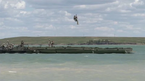 Soldier descends on ropes from a helicopter during training exercises Video stock 84575331