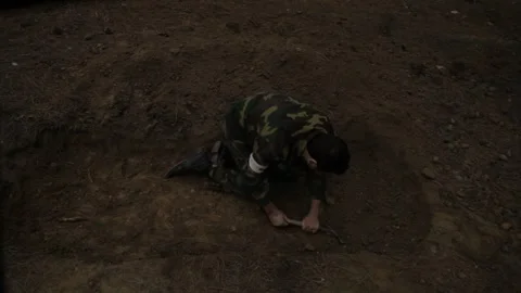 A soldier is digging in the forest 6 Stock Footage 323020154