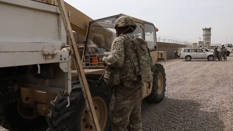 Soldier directing telescopic handler operator with hand signals Stock Footage 87825748
