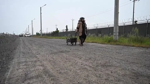 Soldier dressed in bomb suit pulling cart Video stock 161955582