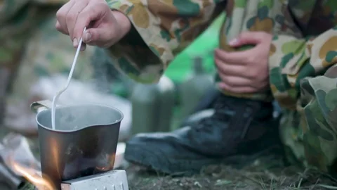 Soldier eating in forest Stock Footage 77016390