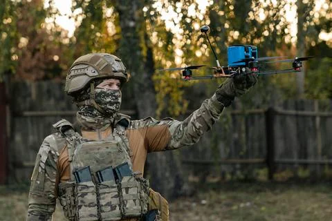 Soldier engineer is preparing reconnaissance FPV drone for flight. Concept .. Stock Photos
