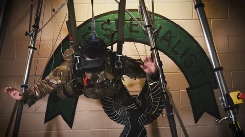 Soldier experiencing virtual reality training with headset and harness Stock Footage 103310688