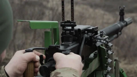 A soldier fires a machine gun, close-up, the end of the machine gun belt Video stock 267315221