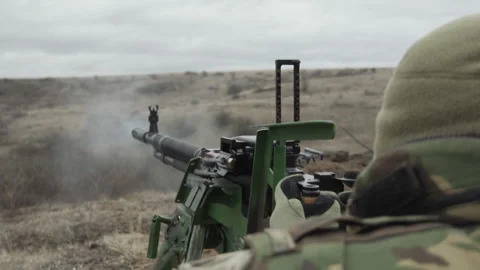 A soldier fires a machine gun, close-up, the end of the machine gun belt Video stock 267315609