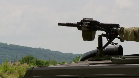 A soldier firing from an automatic machine-mounted grenade launcher Video stock 112629298