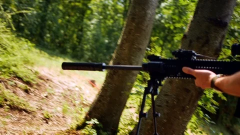 A soldier going forward in forest with his automatic machine gun. 4k Stock-Footage 120517750