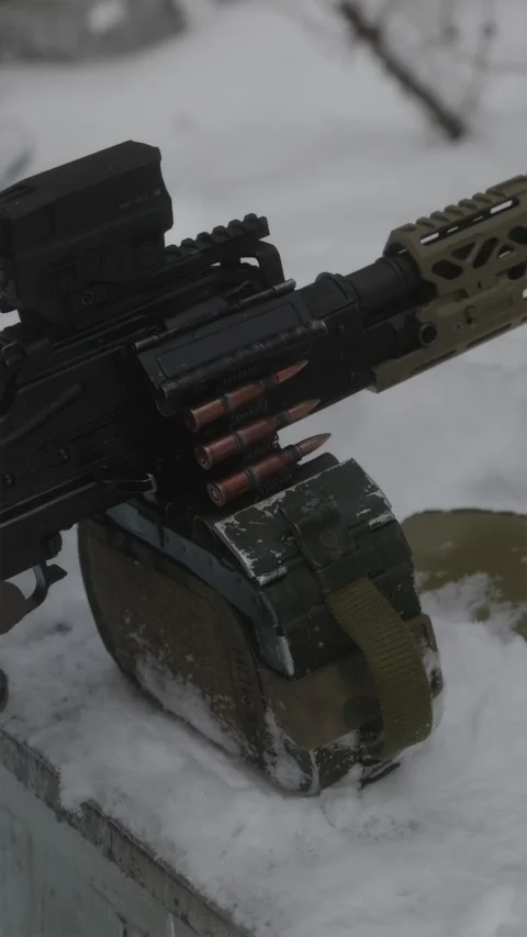 Soldier hands operating PKM machine gun on snowy firing range Stock Footage 333612780