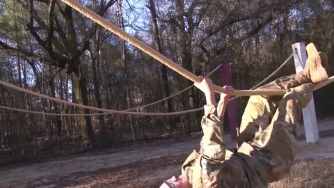 Soldier hanging using rope bridge during basic training at Fort Benning, Georgia Video stock 82936182