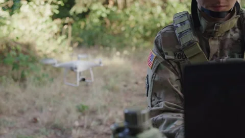 Soldier on Her Computer Controlling the Drone Behind Her 스톡 동영상 208791322