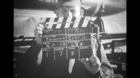 Soldier holding a clapperboard and focus on parts of Honest John rocket Stock Footage 39916177