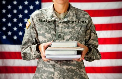 Soldier: holding stack of text books Stock Photos