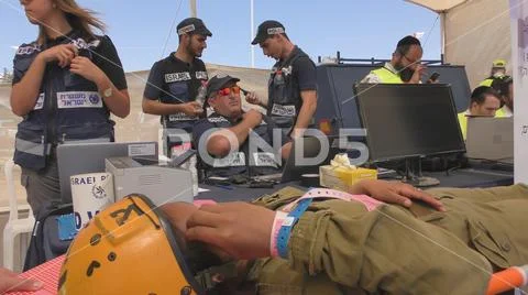 A soldier injured from earthquake rocket attack tsunami waits identification Stock Photos
