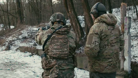 A soldier with an instructor takes aim and shoots at targets. 4k slow motion Video stock 170450807