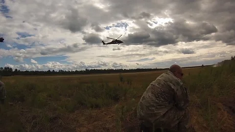 Soldier lands on the ground using rope from an HH-60 Blackhawk helicopter - 2013 Stock Footage 102233547