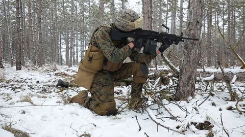 Soldier lie down on the ground, aiming. another reported the situation by radio Stock Footage 127618868