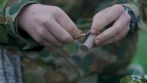 Soldier lighting fire in forest Stock Footage 77016247