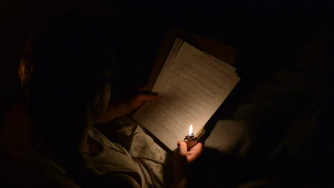 A soldier lighting a zippo lighter to read a letter the dark Stock Footage 217356045