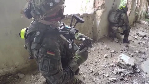 Soldier loading pistol inside derelict building during live fire exercise 動画素材 93390115