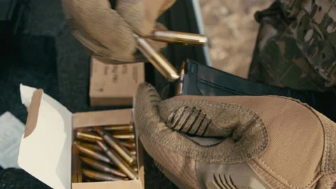 A soldier loads cartridges into the magazine, preparing for battle. slow motion Stock Footage 170451853